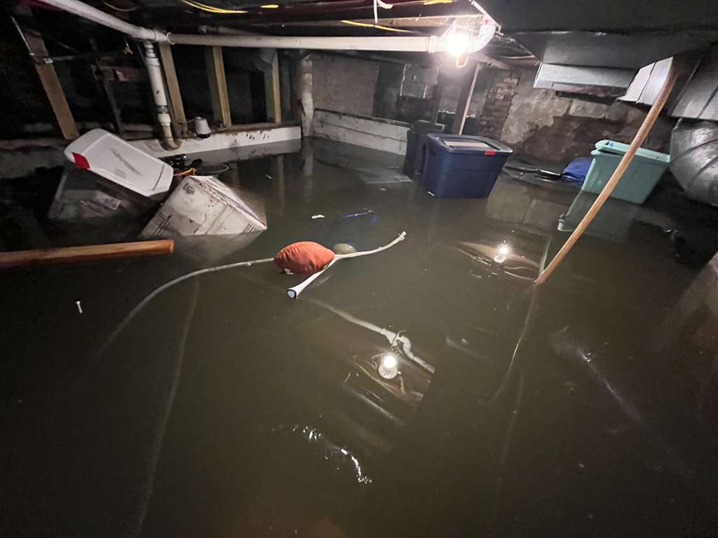 Assessing a flooded basement in Grand Rapids